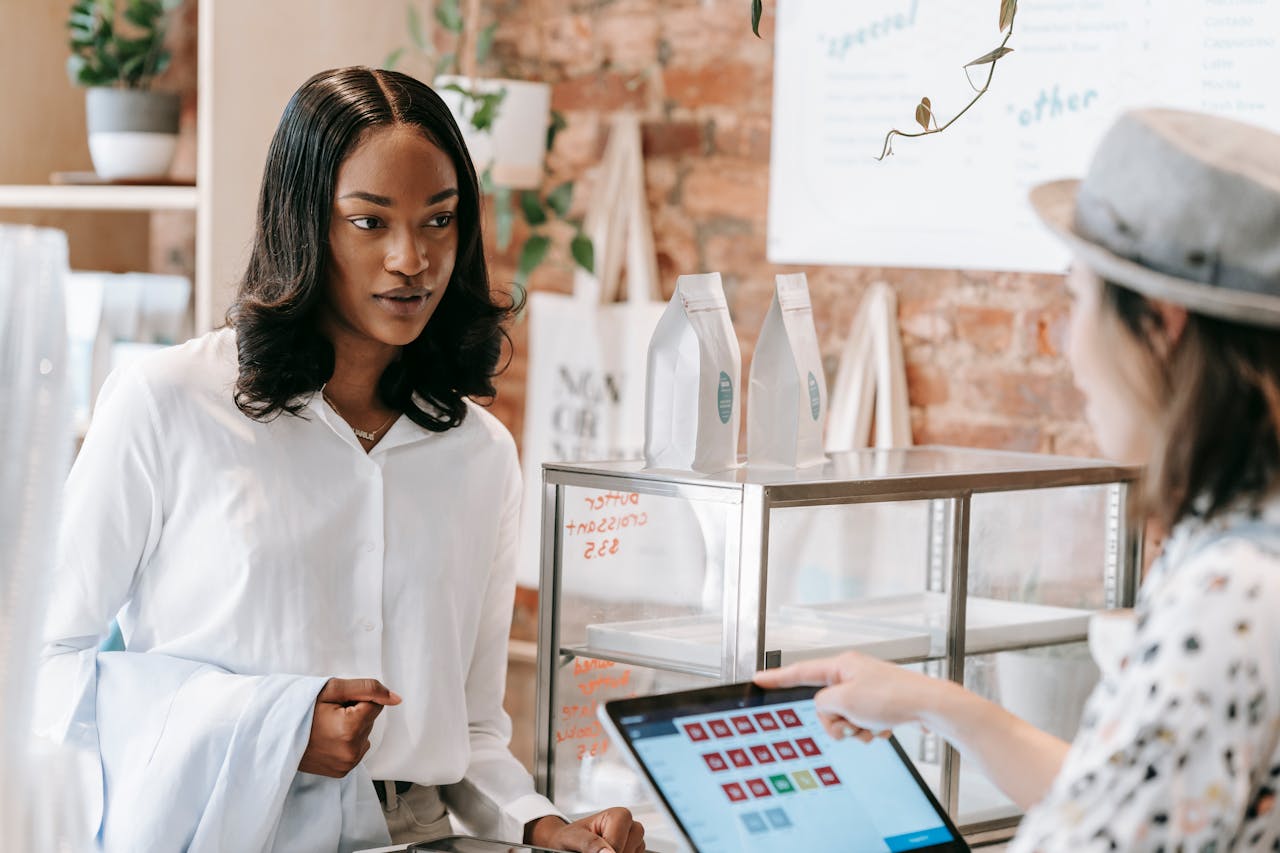 A customer interacts with a barista at a trendy coffee shop counter, showcasing modern retail service.